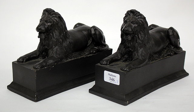 Appraisal: A PAIR OF BLACK PAINTED COMPOSITE BOOK ENDS in the