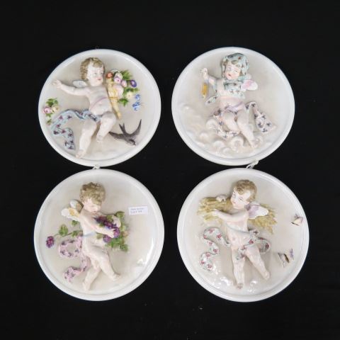 Appraisal: Set of Four Seasons Porcelain Cherub Plaques raised designs circa