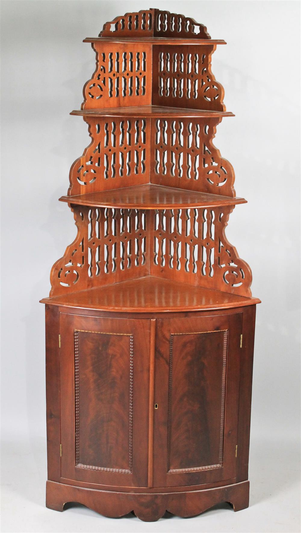 Appraisal: MAHOGANY OPEN CORNER CUPBOARD in two parts the upper section