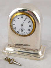 Appraisal: A silver miniature mantel clock with enamel face and seconds