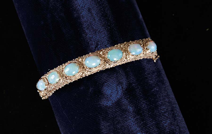 Appraisal: OPAL BANGLE BRACELET Very pretty k yellow gold bangle has