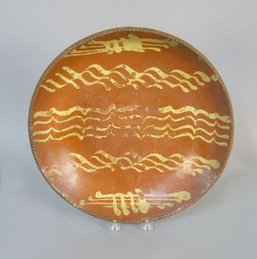 Appraisal: Redware charger th c with yellow slip decoration dia