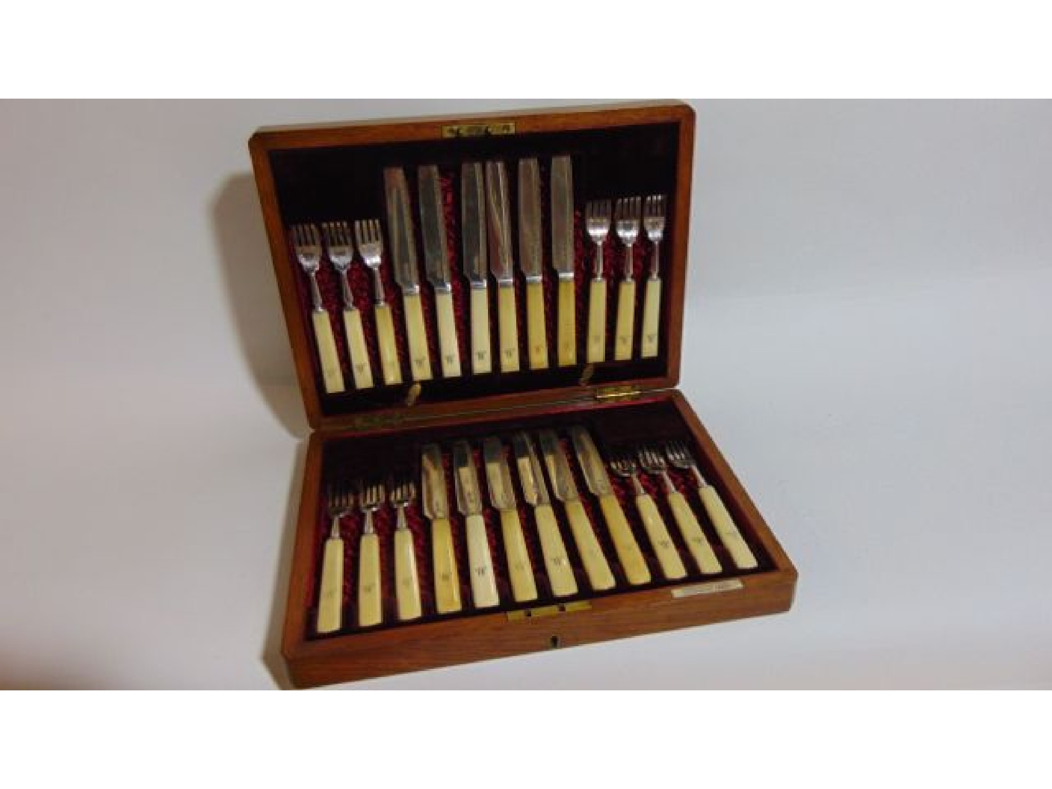 Appraisal: A cased set of twelve fruit forks and twelve fruit