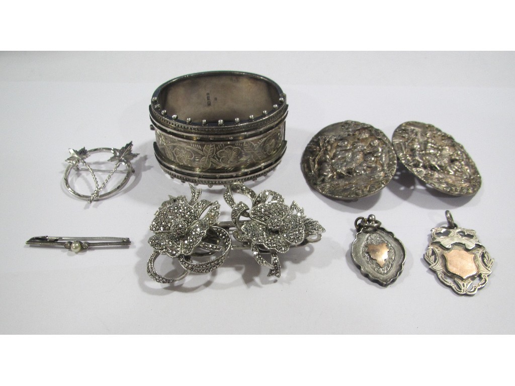 Appraisal: Lot comprising a silver buckle highly embossed to depict cherubs