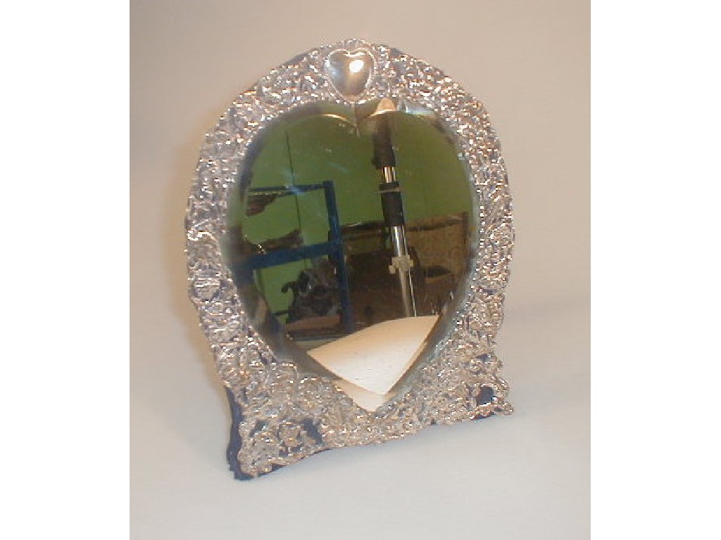 Appraisal: A Victorian silver toilet mirror the heart-shaped bevelled glass within