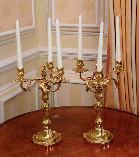 Appraisal: A PAIR OF LOUIS XV STYLE ORMOLU THREE BRANCH CANDELABRA