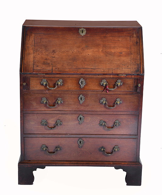 Appraisal: A GEORGE II MAHOGANY BUREAU the fall front opening to