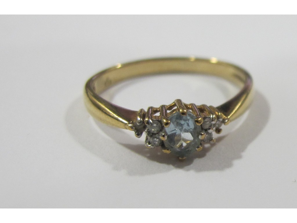 Appraisal: Nine carat gold blue topaz and diamond set dress ring