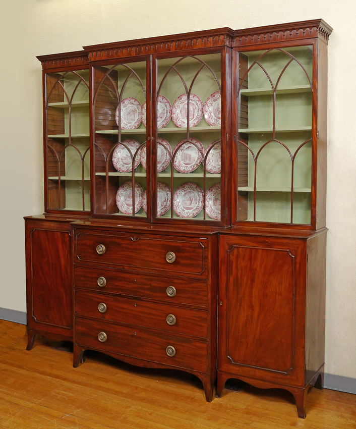 Appraisal: GEORGIAN MAHOGANY BREAKFRONT SECRETARY DESK section top architectural fretwork glass