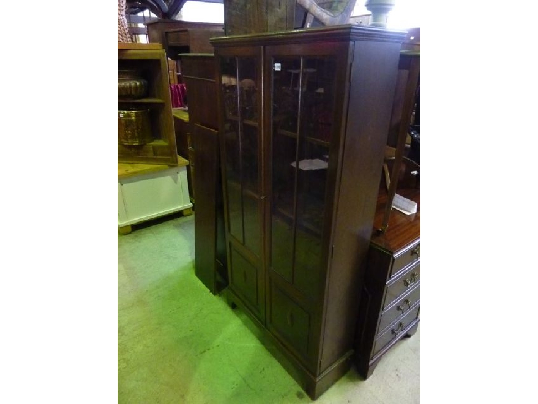 Appraisal: An Edwardian s oak freestanding bookcase side cabinet enclosed by