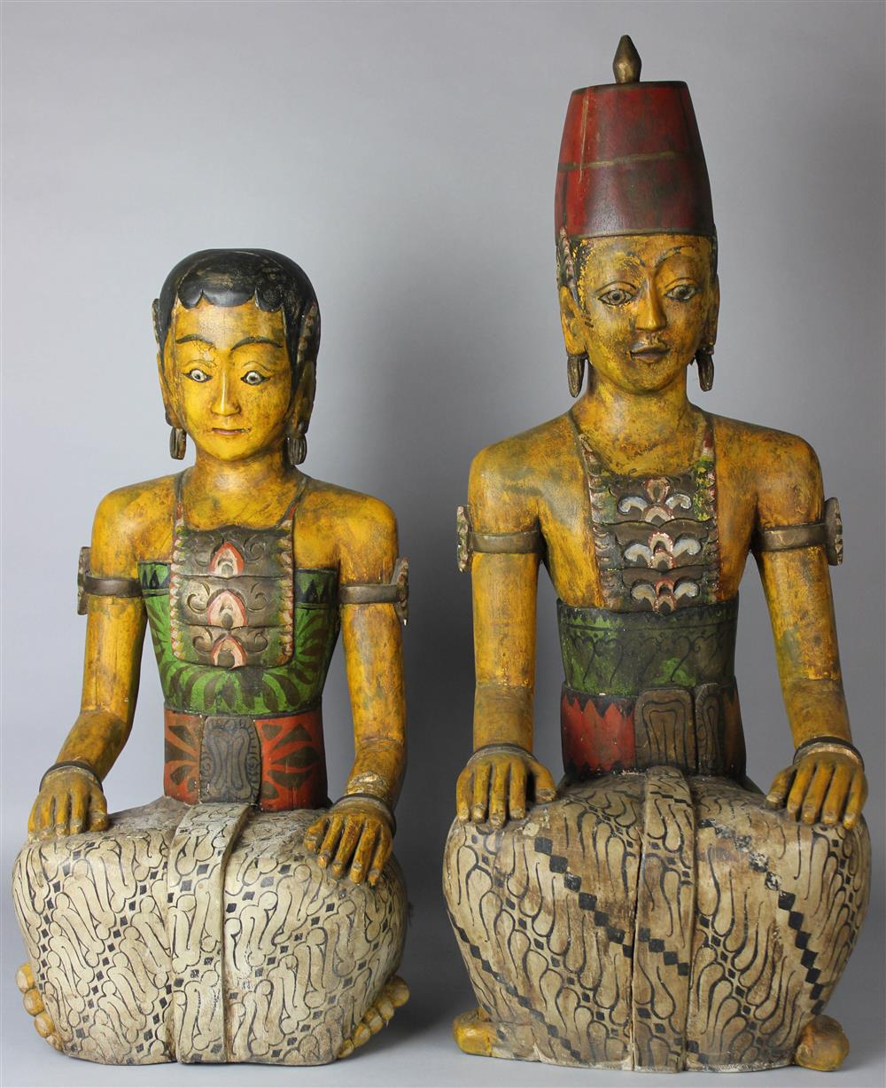 Appraisal: TWO INDONESIAN PAINTED WOOD FIGURES OF ATTENDANTS MODERN both carved