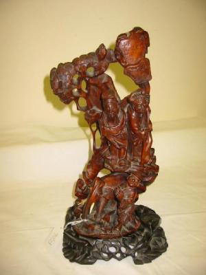 Appraisal: AN ORIENTAL ROOTWOOD FIGURAL GROUP carved as three figures and