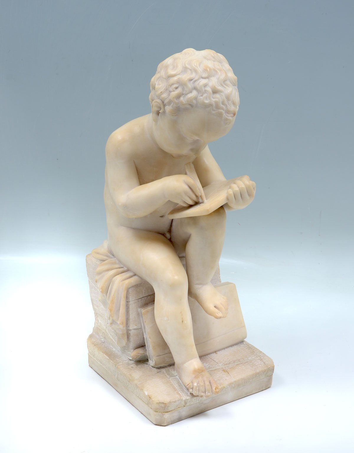 Appraisal: FINELY CARVED FIGURAL MARBLE SCULPTURE OF A YOUNG BOY WRITING