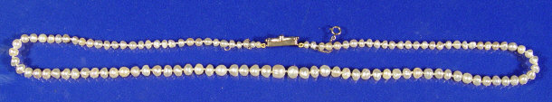 Appraisal: String of seed pearls on a white gold and diamond