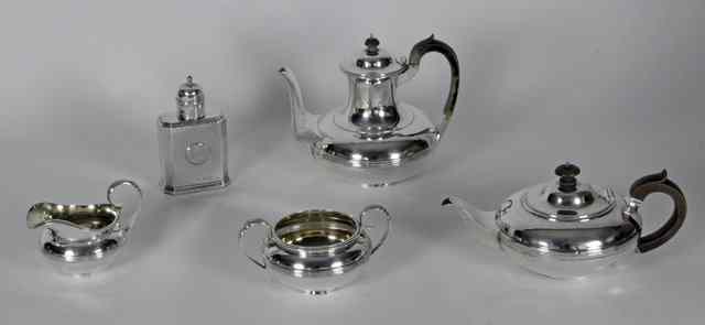 Appraisal: A silver four-part tea service London and with a strainer