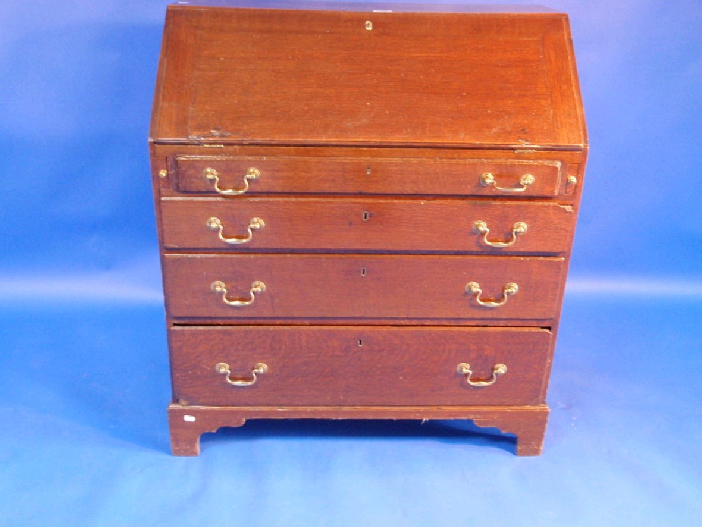 Appraisal: A Geo III oak bureau with fall flap revealing a