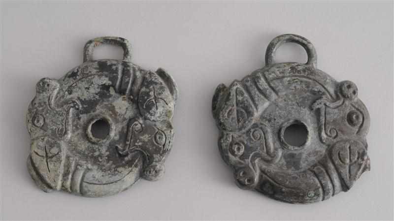 Appraisal: PAIR OF WESTERN ZHOU ARCHAIC BRONZE CHEEK PIECES Each modeled