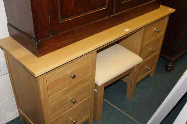 Appraisal: A LIGHT OAK DRESSING TABLE and stool fitted with an