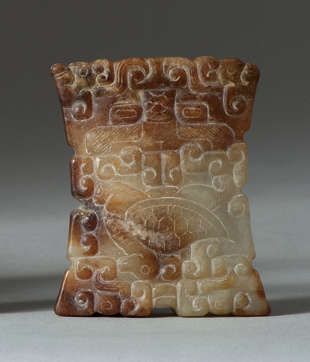 Appraisal: BROWN AND WHITE JADE BEAD In modified rectangular form with