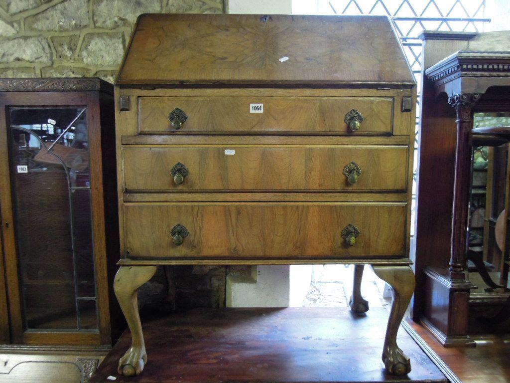 Appraisal: A reproduction walnut and figured walnut veneered bureau the fall