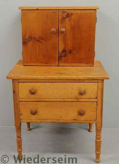 Appraisal: Continental pine two-part cabinet c with two doors above a