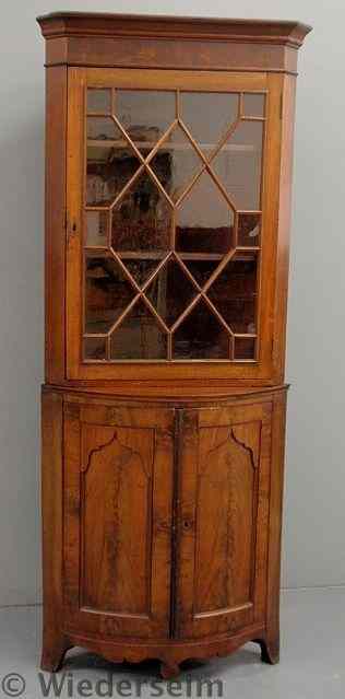 Appraisal: English mahogany corner cupboard with a molded cornice and mullioned