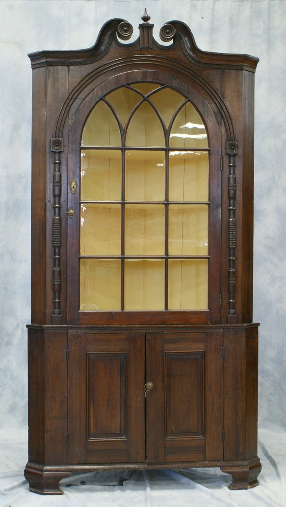 Appraisal: Two piece poplar corner cupboard scrolled pediment top light arched