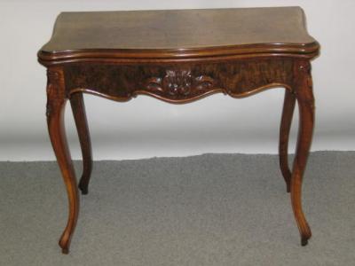 Appraisal: A LATE VICTORIAN WALNUT FOLDING CARD TABLE of oblong serpentine