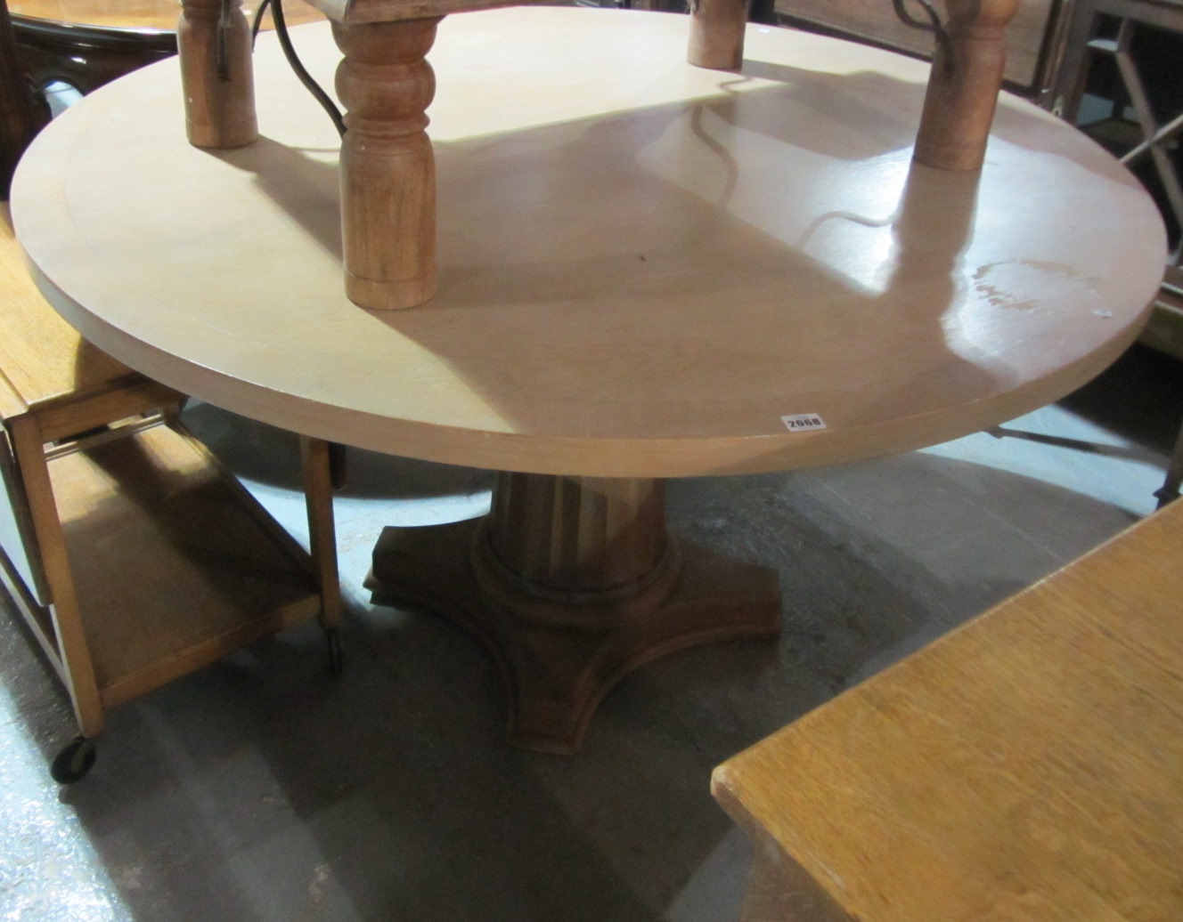 Appraisal: A th century circular dining table with a painted column