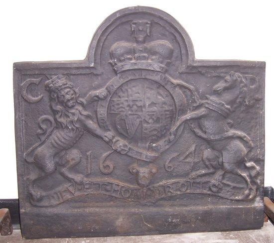 Appraisal: A cast iron arch top fireback bearing the Royal cipher