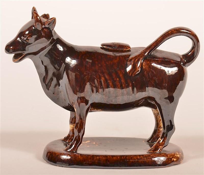 Appraisal: Rockingham Glazed Yellowware Cow Creamer Rockingham Glazed Yellowware Cow Creamer