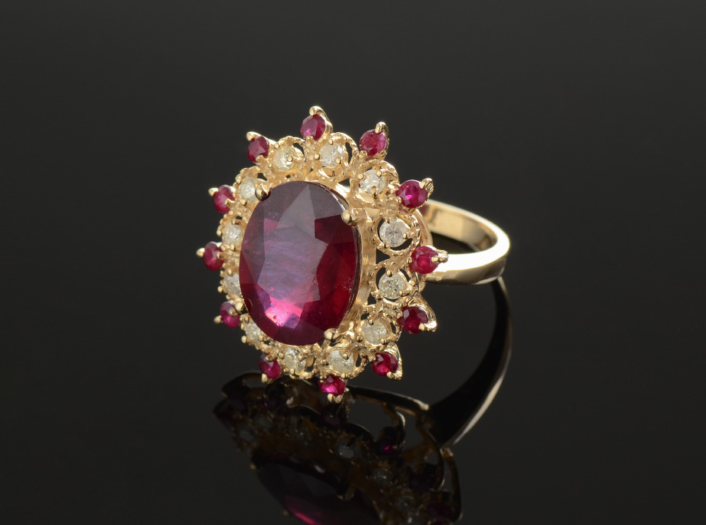 Appraisal: A REGAL RUBY AND DIAMOND RING At the center is