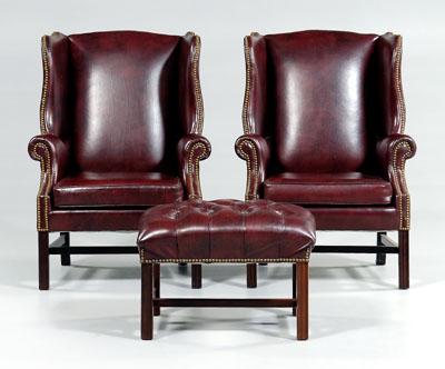 Appraisal: Pair leather wing chairs ottoman each leather upholstered with brass