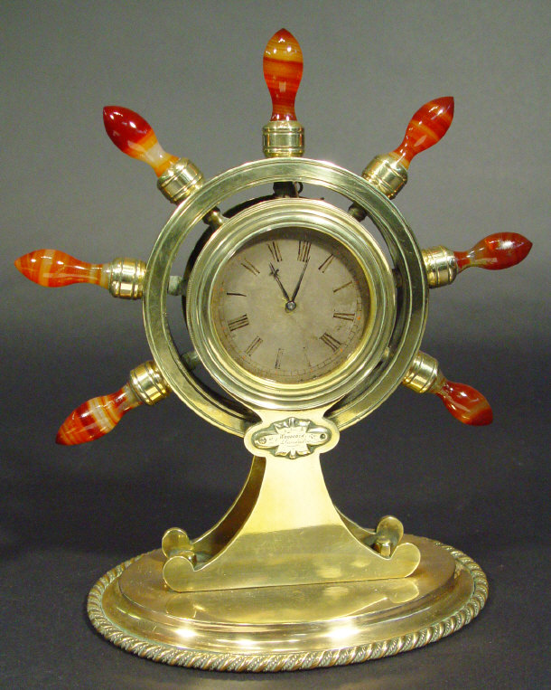 Appraisal: Brass ship's wheel mantel clock set with turned hardstone handles