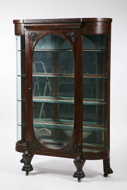 Appraisal: CHINA CABINET Oak with curved sides shell carved decorated door