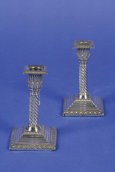 Appraisal: A PAIR OF VICTORIAN CANDLESTICKS with wrythen stems applied acanthus