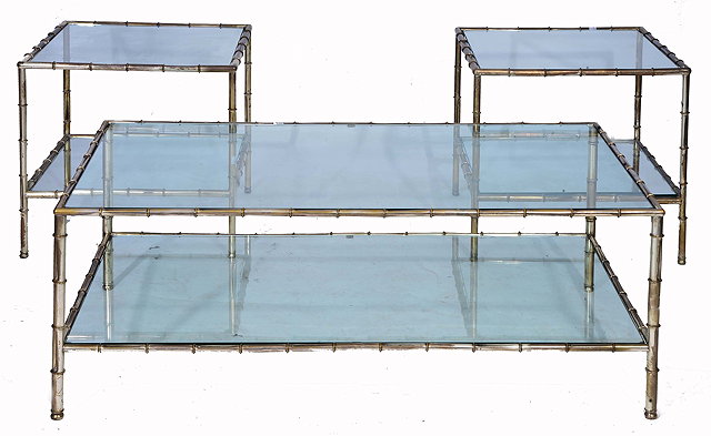 Appraisal: A SET OF THREE SILVERED METAL AND PLATE GLASS TABLES