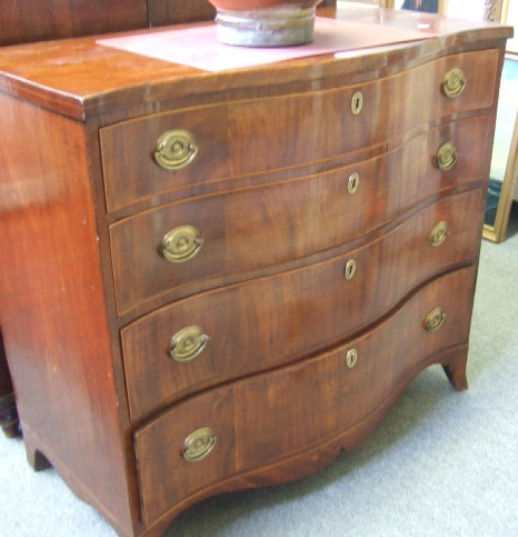 Appraisal: An early th century mahogany line inlaid serpentine chest of