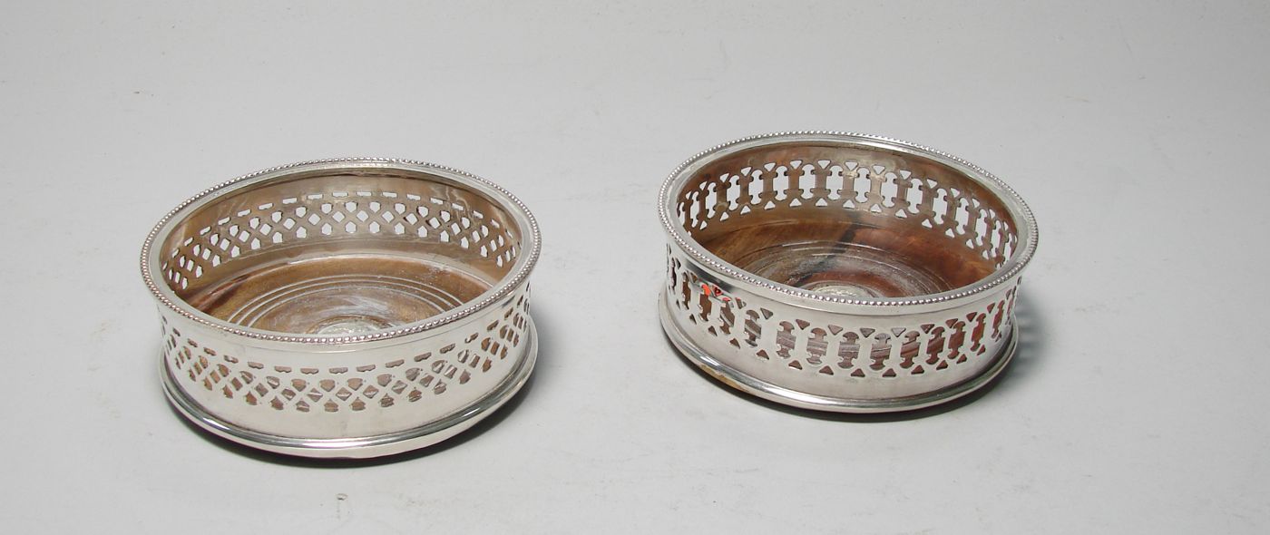 Appraisal: TWO ENGLISH SILVER PLATED WINE COASTERS th CenturyWith fenestrated sides