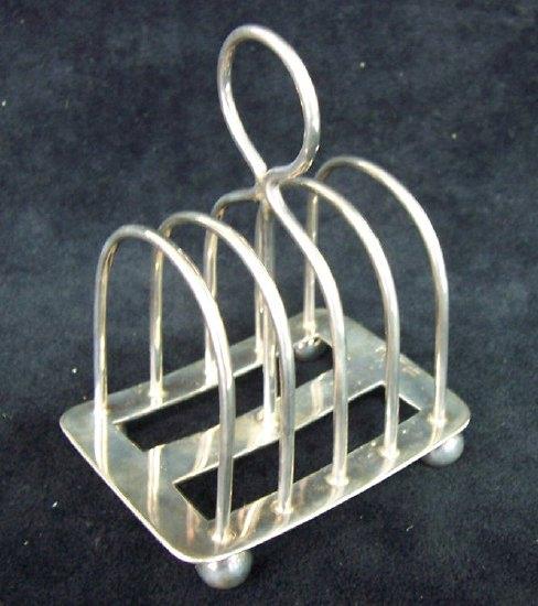 Appraisal: A five bar toast rack with ring handle on four