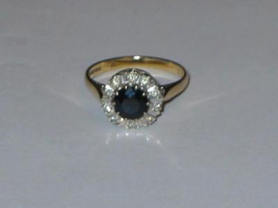 Appraisal: A DIAMOND AND SAPPHIRE CLUSTER RING the central round cut