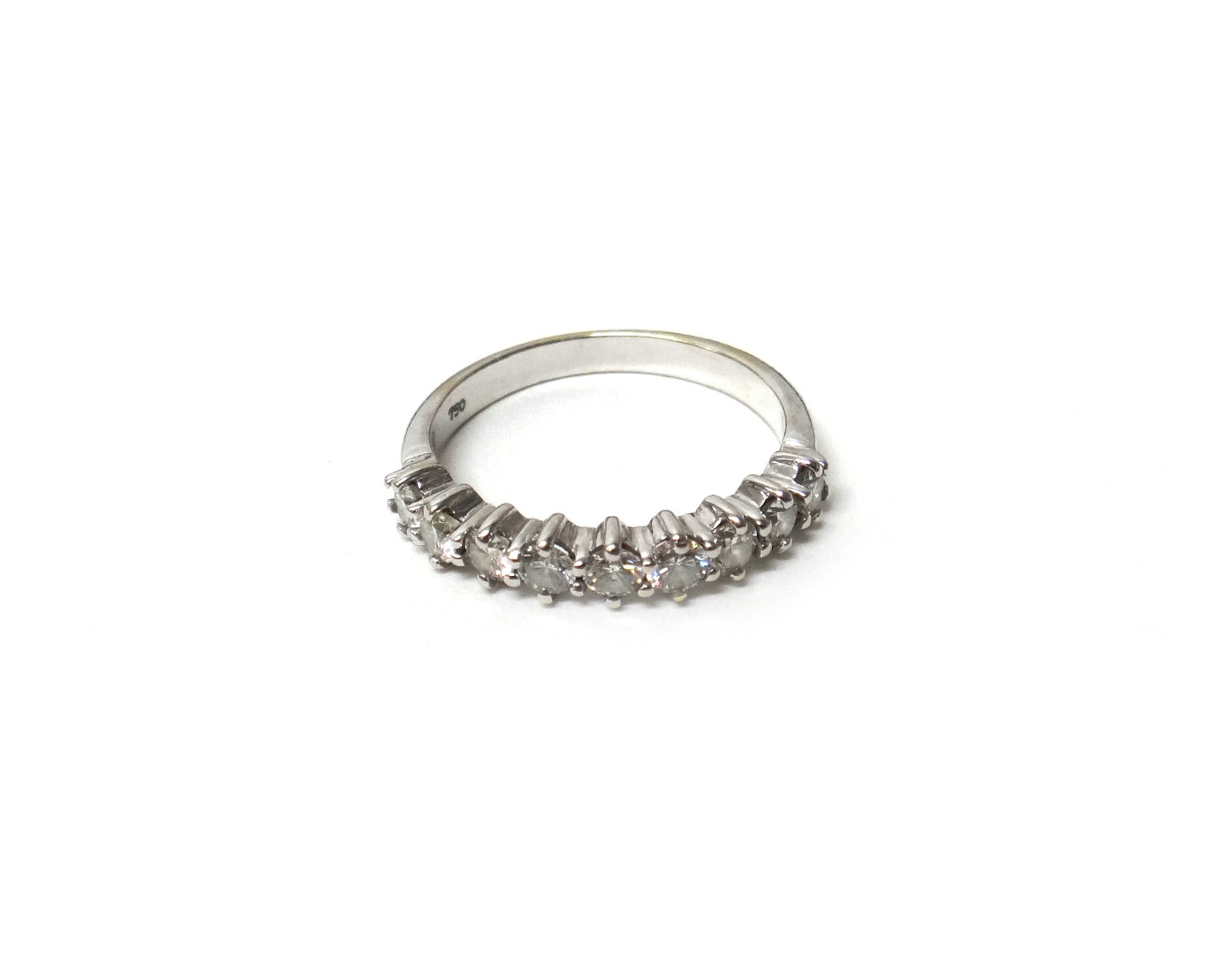 Appraisal: A white gold and diamond nine stone half hoop eternity