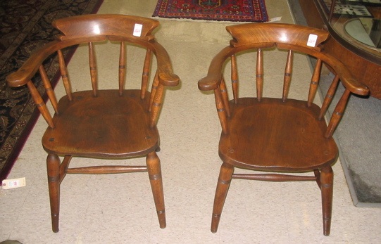 Appraisal: A PAIR ELMWOOD CAPTAIN'S ARMCHAIRS with matching horseshoe-shaped arm rails