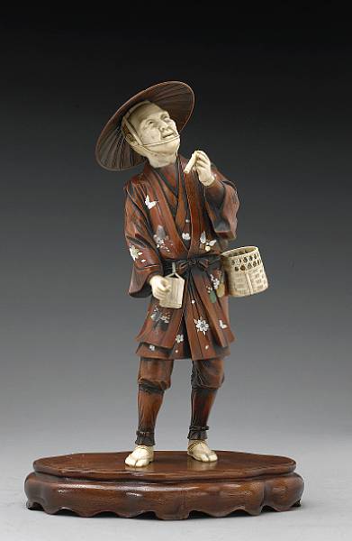 Appraisal: An ivory and inlaid wood figural okimono Meiji Period Portraying