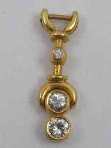 Appraisal: A three stone diamond pendant set in yellow metal tests