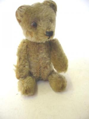 Appraisal: A Schuco perfume bottle teddy bear covered in beige plush