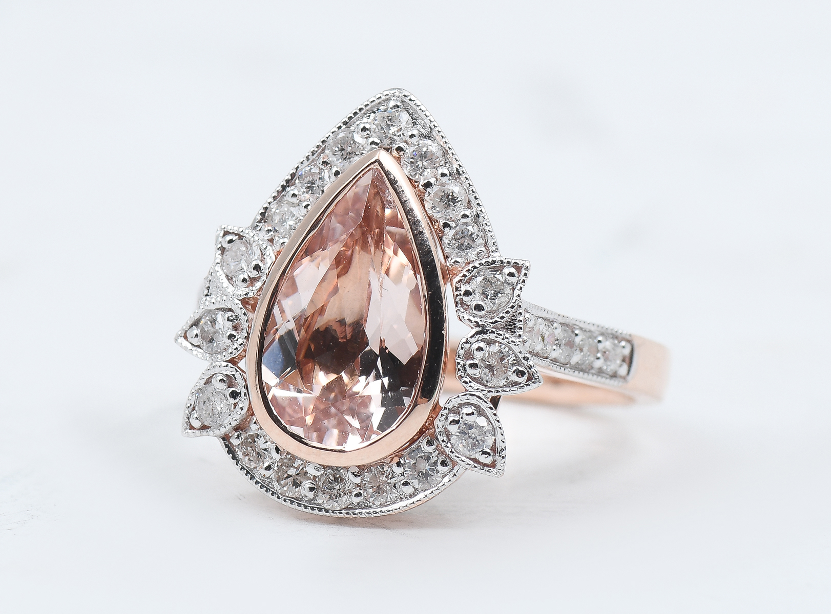 Appraisal: K MORGANITE RING WITH DIAMONDS CT pear shaped morganite is