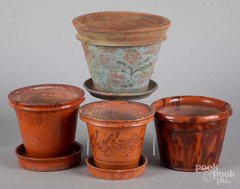 Appraisal: Four Pennsylvania redware flower pots th c Four Pennsylvania redware