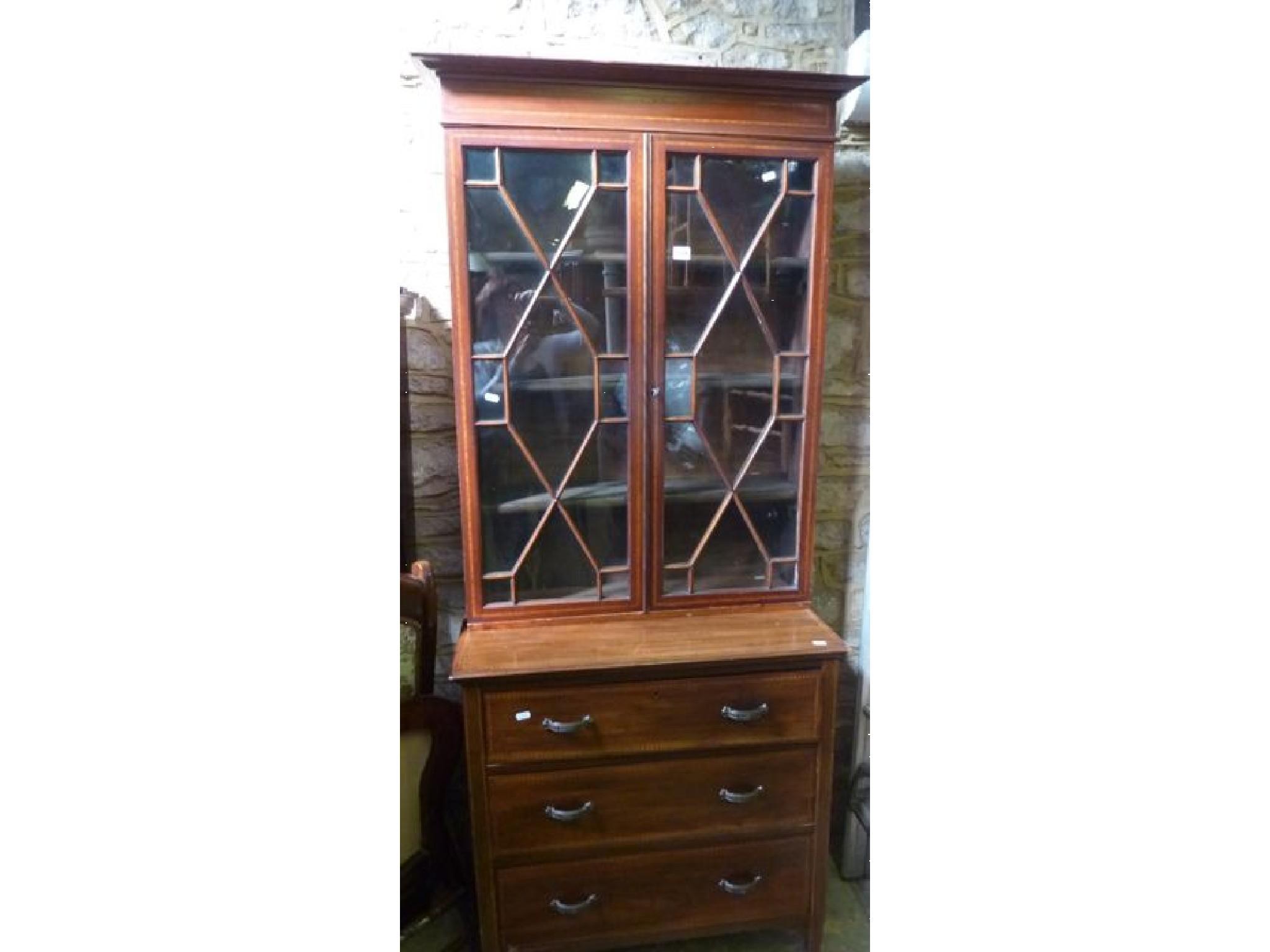 Appraisal: An inlaid Edwardian mahogany bookcase in the Georgian style enclosed