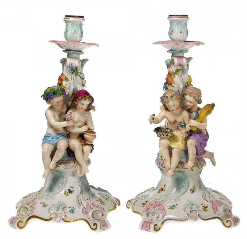 Appraisal: A PAIR OF GERMAN FLORAL ENCRUSTED CANDLESTICKS the scrolling pale